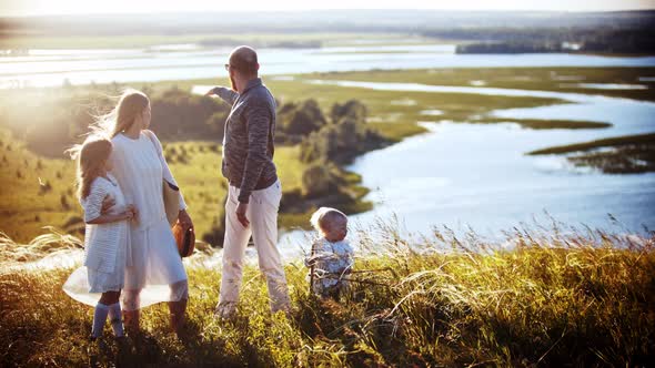 Young Slavic Family Standing on the Wheat Field and Looking Around