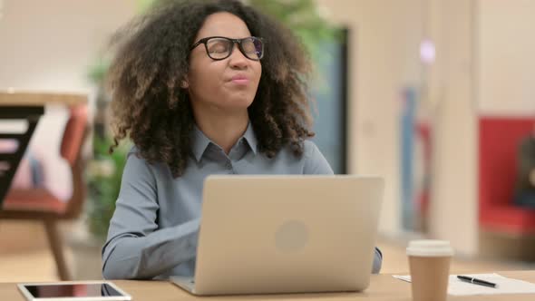 Young African Woman with Laptop Having Neck Pain