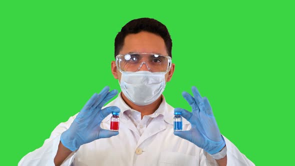 Doctor Showing in Hands Two Vial or Ampoules Concept of Choice Treatment on a Green Screen Chroma