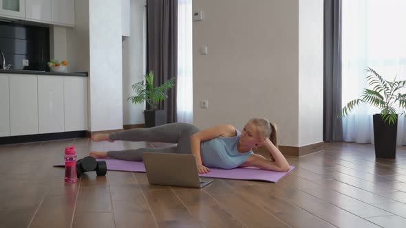 Woman Training Legs Watching Video Laptop