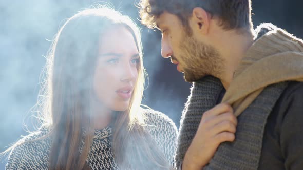 Woman looking at her boyfriend while he is smoking