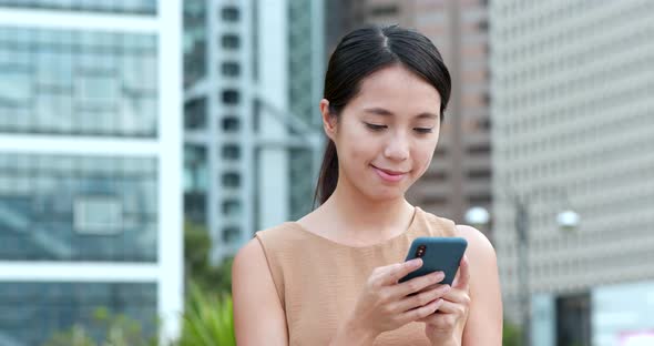 Woman use of mobile phone in city of Hong Kong