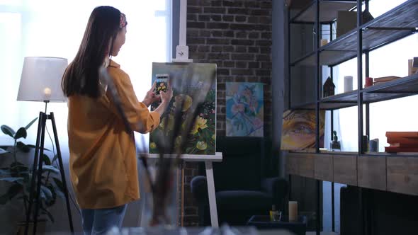 Artist Taking Photo of Canvas with Flowers