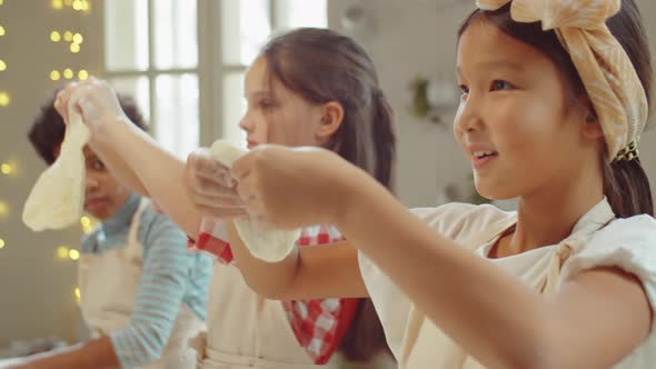 Cute Asian Girl Preparing Dough during Cooking Class