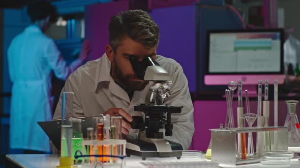 Bearded Scientist Studying Sample alt