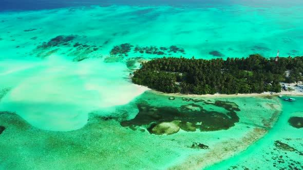 Wide aerial island view of a white sandy paradise beach and blue sea background in best quality 4K