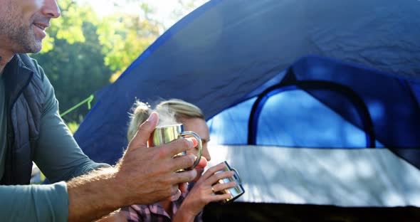 Family having coffee outside the tent