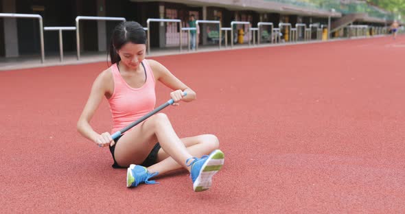 Sport woman using roller stick in sport stadium 