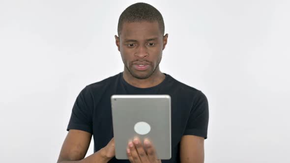 Young African Man Using Digital Tablet on White Background