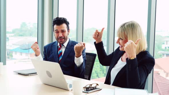 Two Happy Business People Celebrate at Office