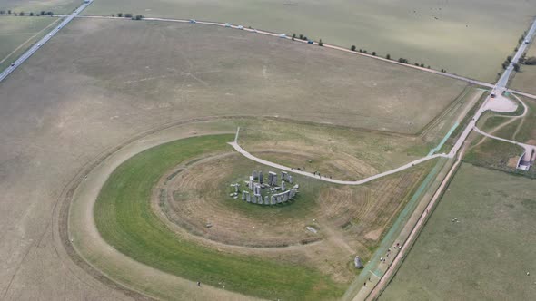 Cinematic dolly forward pan down aerial drone shot of Stonehenge UK