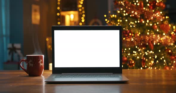 Laptop with blank screen and Christmas tree