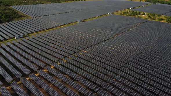 Aerial pan up, field of solar panels generating renewable sustainable green energy