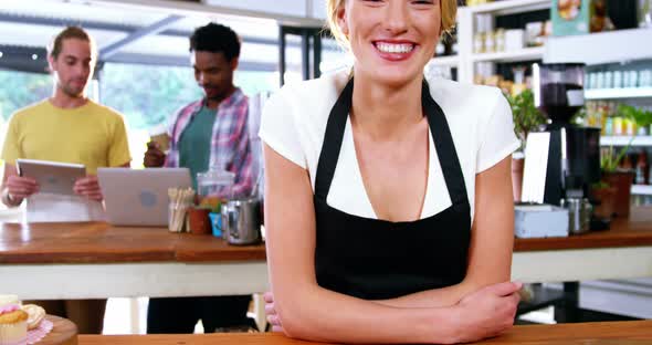 Portrait of waitress standing behind the counter