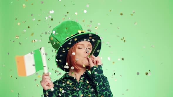 Woman blowing party horn blower under shower of confetti