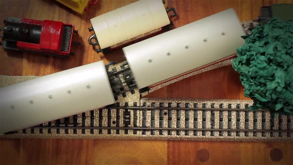 Model Train Locomotive with Carriages on Railway Tracks. High Angle View.