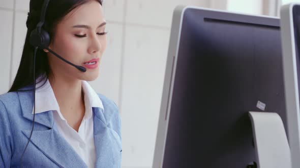 Customer Support Agent or Call Center with Headset Talking to Customer on Phone