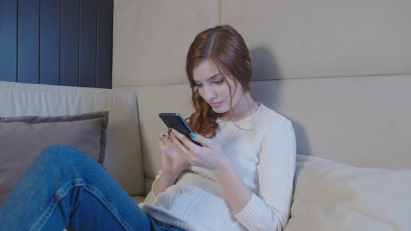 Relaxed Young Woman Using Smart Phone Chatting In Dating App Euphoric Overjoyed 