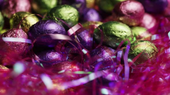 Rotating shot of colorful Easter candies on a bed of easter grass