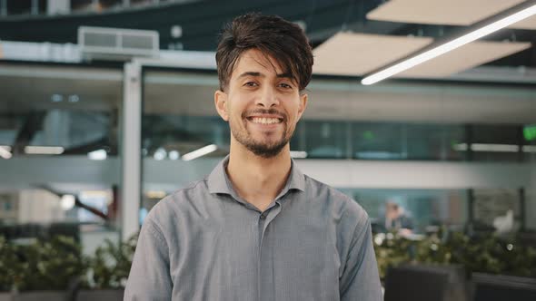 Happy Indian Bearded Handsome Adult Man Stand in Hall Office Smiling Looking at Camera Cheerful Male