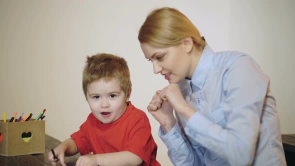 Preschool Child. Cute Little Son with Mother Having Fun and Using Paints.