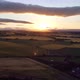 Shooting From a Drone of a Sunset with Green Fields - VideoHive Item for Sale