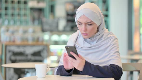 Disappointed Young Arab Woman Having Loss on Smartphone