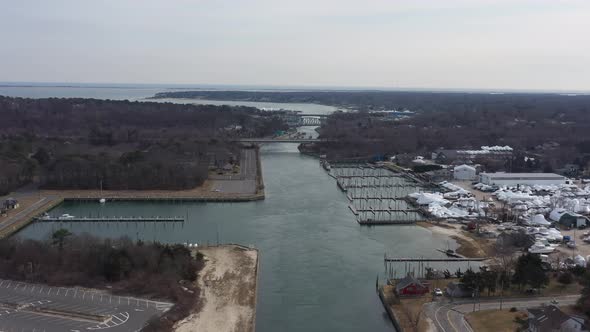 An aerial view over the Shinnecock Canal in Hampton Bays, Long Island, NY. The drone camera dolly in