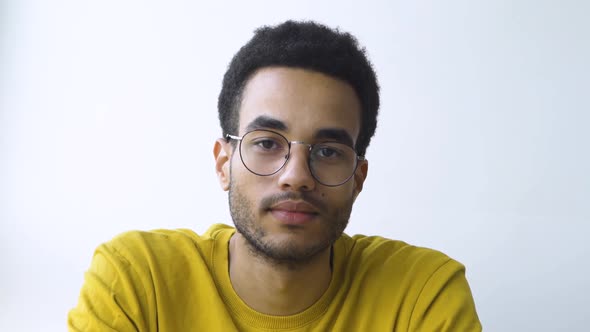 A Confident AfricanAmerican Man Looks at the Camera