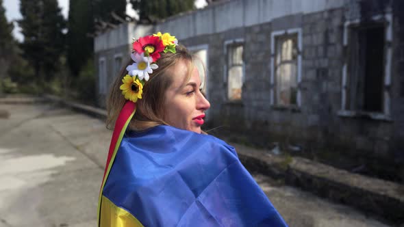 Ukrainian Girl Cries Near the Destroyed House Flag of Ukraine