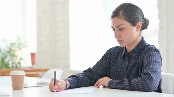 Young Indian Woman Writing on Paper 