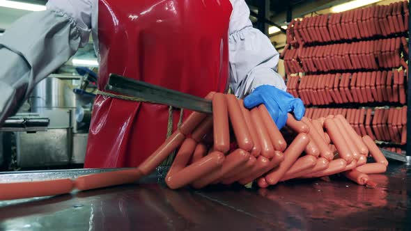 Plant Employee Is Getting Sausages Onto a Metal Bar
