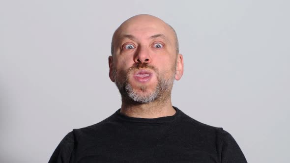 comic and funny man makes funny faces at the camera