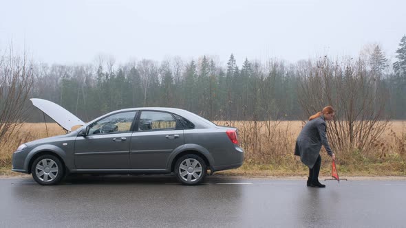 Caucasian Woman Installing Red Triangle Sign on Road