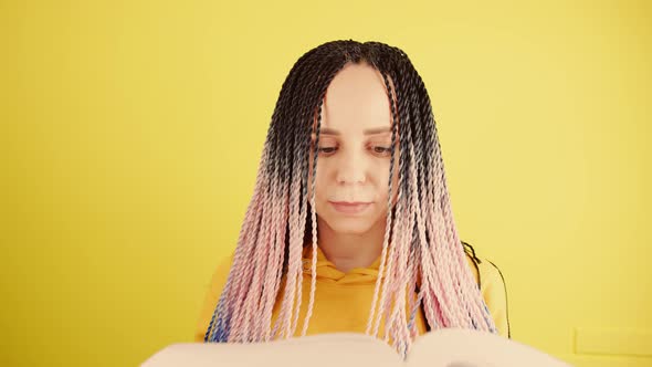 Young Woman with Senegalese Pigtails Reading Book