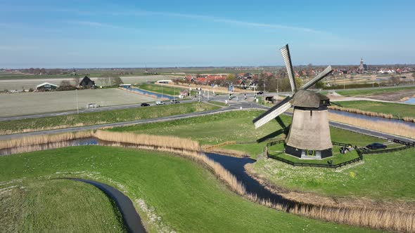 Historic Dutch Windmills in a Farm and Grass Field Landscape in The Netherlands Holland