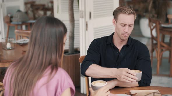 Young Couple Drinking Coffee in Cafe, Guy and Girl Talking and Laughing