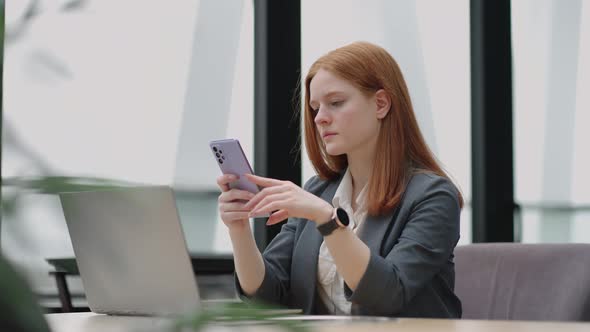 Young Businesswoman Use Smart Phone with Laptop