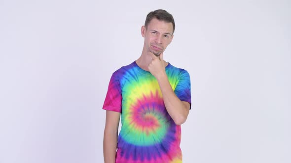 Studio Shot of Man with Tie-dye Shirt Thinking