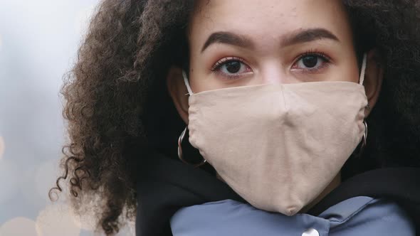 Close Up Female Masked Face Serious Dark Skinned Curly Woman Standing at Public Place Wears