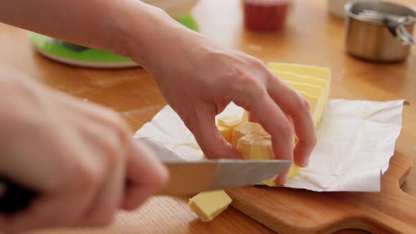 Hands Cutting Butter and Putting on Scale