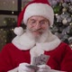 Cheerful Elderly Man Dressed Like Santa Claus Quickly Counts Money at Home Against the Background of - VideoHive Item for Sale