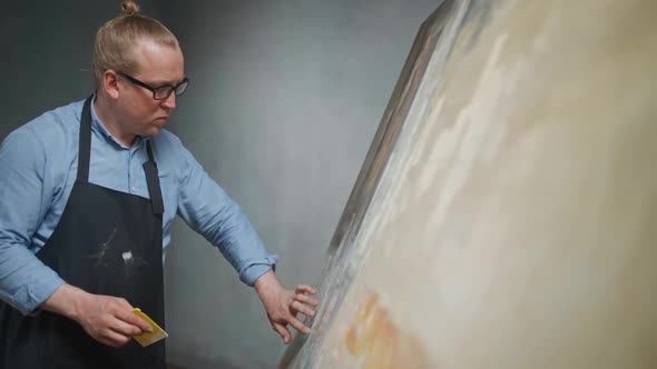 Art Studio Creative Person in a Blue Shirt and Glasses at Work a Talented Adult Male Artist Draws an