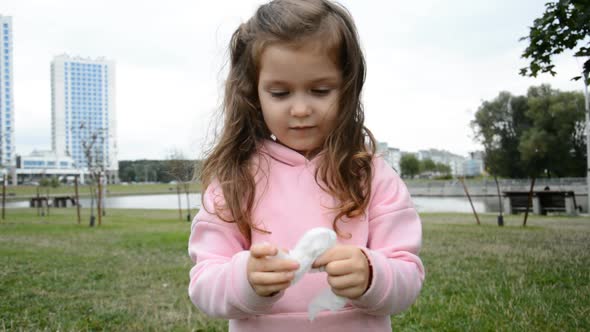 Little Girl Wipes Her Hands with Antibacterial Wipes