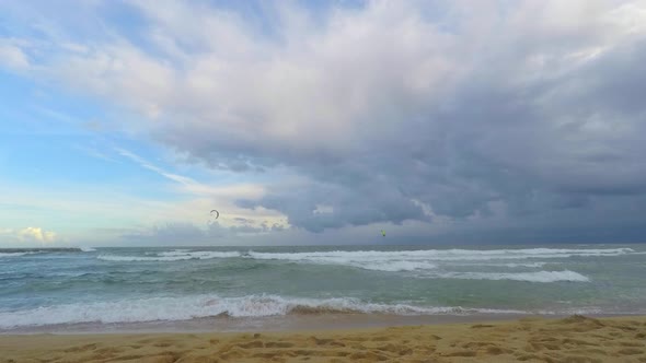 Waves Hit The Beach And So Do The Surfers