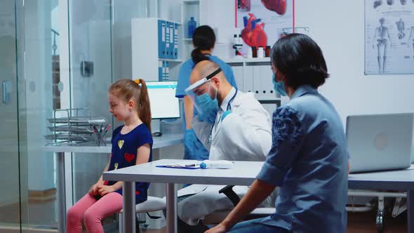 Pediatric Physician with Stethoscope Listening Breath of Girl