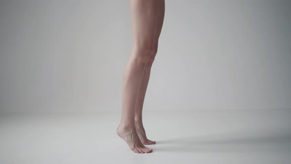 Female Legs Close Up. Girl Spinning on Tiptoes Barefoot