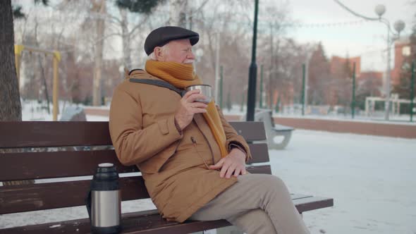 Senior Man Drinking Tea on Bench