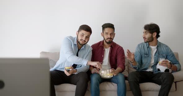 Three Indian Young Men Watching Football at Home