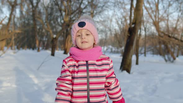 Smiling Child Kid Walking Having Fun Relaxing Looking Around on Snowy Road in Winter Park Forest